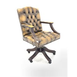 Antique design desk chair, upholstered in deep buttoned and studded tan leather, raised on swivel base with castors W61cm