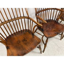 Set of four elm and oak Windsor armchairs, double hoop and high comb back, dished saddle type seat, on turned supports joined by crinoline stretcher 