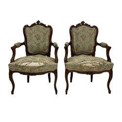 Pair of Victorian armchairs, the walnut show frame with floral upholstery, raised on cabriole supports  