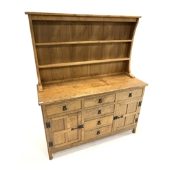 'Acornman' Yorkshire oak dresser, with two height plate rack over five drawers and two panelled cupboards, each enclosing a shelf, raised on octagonal turned supports, carved with acorn signature, W137cm, H167cm, D49cm