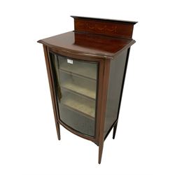 Edwardian mahogany bow front music or display cabinet, raised back with inlaid satinwood garlands and stringing, glazed cupboard door enclosing three shelves, raised on square tapering supports 
