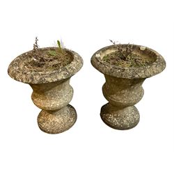 Pair of weathered cast stone garden urns of Campana form