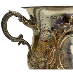 Large Victorian silver two handled cup with embossed floral decoration, vacant cartouches, scroll handles and domed pedestal foot H28cm London 1860 Maker possibly Rotheram & Sons