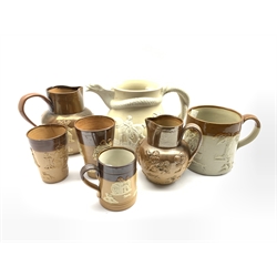Collection of Doulton Lambeth relief moulded jugs, beakers and other stoneware together with a Victorian stoneware jug with serpent moulded handle, H19cm (7)