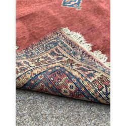 Persian Hamadan red ground rug with pole medallion, enclosed by border 218cm x 125cm