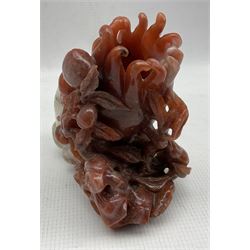 Chinese red and white Carnelian agate vase pierced and carved with a fruiting tree with peaches on a gnarled base H13cm x W12cm