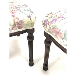 Pair late 19th mahogany side chairs, the fluted and flower head carved cresting rail over a horizontally pierced back, moulded uprights, seats upholstered in floral cover, turned and reeded supports, seat width - 48cm, seat height - 44cm