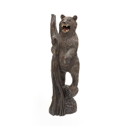 Black Forest carved wooden figure of a standing bear holding a branch H103cm