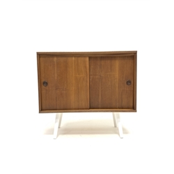 Mid century Danish teak PS systems cabinet, with two sliding doors, raised on tapered white supports, W71cm