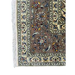 Fine Persian Kashan rug, ivory ground and decorated all-over with stylised plant motifs and trailing foliage, central medallion within shaped field, multi-band border decorated with repeating scroll design