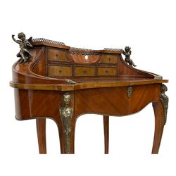 Mid-20th century Louis XV design Kingwood and walnut Bonheur de Jour or writing desk, kidney shaped form, the raised galleried back with concaved centre surrounded by small drawers, sweeping sides mounted by cast winged putto figures enclosing leather writing surface, fitted with frieze drawer, on cabriole supports mounted by winged caryatid figures with brass beading and scrolled acanthus leaf feet caps