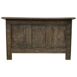 17th century design oak coffer or chest, rectangular hinged top with gadrooned edge, the panelled front carved with three foliate lozenges, flanked by stylised palm uprights, the lower frieze rail carved with lunettes, on stile supports