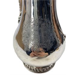 Early George III silver hot water jug of baluster form with gadrooned decoration to the cover and foot, urn finial and stained wood handle, engraved with a coat of arms H26cm London 1766 Maker David Whyte and William Holmes 