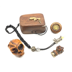 Japanese Meiji hardwood Tonkotsu or box and cover, the top applied with carved ivory leaves, Japanese carved wooden netsuke in the form of a skull, carved claw seal with brass matrix etc (4)