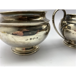 Silver circular sugar bowl on a short pedestal foot and matching cream jug Birmingham 1920 6.49oz