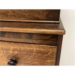 George III oak and mahogany cupboard on secretaire, projecting cornice over two panelled doors enclosing shelves, fall front secretaire drawer with fitted interior above three long drawers, W116cm, H214cm, D50cm