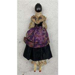 19th century painted wood peg doll, with carved and painted features, painted black hair with curls and tuck comb, peg jointed at the shoulders, elbows, hips and knees, painted white lower legs and arms, red slippers, original purple dress with point lace detail, L16cm 