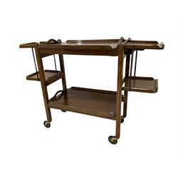Early 20th century Art Deco oak two-tier tea trolley, with removable trays and extendable cake stands on each end, supported by fluted uprights on castors