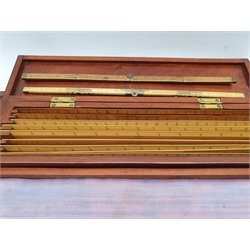 Two mahogany boxes containing a collection of boxwood rulers by various makers but mainly Stanley and J Halden,, some inscribed British Railways, two folding rulers and a set of drawing instruments by Stanley, the box dated 31.8.12 