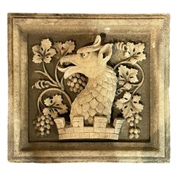 Cast stone heraldic crest, rectangular moulded form with scaled dragon within a rusticated crown, decorated with trailing branches with vine leaves and grape bunches