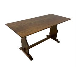 Late 20th century oak dining table, rectangular top on shaped end supports, sledge feet 