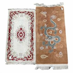 Indian wool white gound rug with floaral design (145cm x 72cm) together with a Chinese brown ground rug, decorated with dragon design (175cm x 76cm)