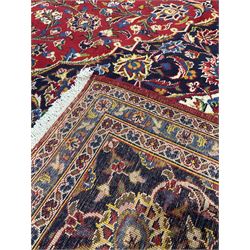 Persian design rug, with red field and navy boarder and floral decoration all over 