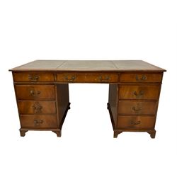 20th century mahogany writing desk, the inset top over one long and eight short drawers, raised on bracket supports 