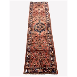 Persian Hamadan runner rug, with stylised medallion on red field, 370cm x 103cm