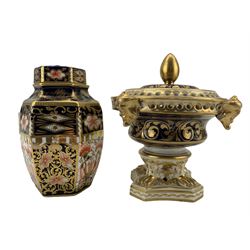 Derby porcelain pot pourri vase and cover, urn form with gilt grotesque masks and pierced rim, raised on four claw feet to a square base, gilt foliate scroll decoration on a blue and white ground, red Nottingham Road mark to base, H14cm, together with Royal Crown Derby Imari pattern hexagonal vase and cover, 1916 date cypher, H12.5cm (2)