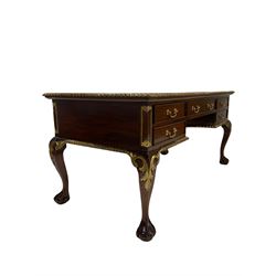 Mahogany writing desk, the rectangular top with gilded and moulded edge over one long and four drawers, raised on ball and claw supports with gilded acanthus leaves 