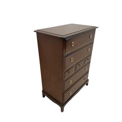 Chest of drawers by Stag, fitted with seven drawers and raised on tapering supports W82cm, H113cm, D47cm 