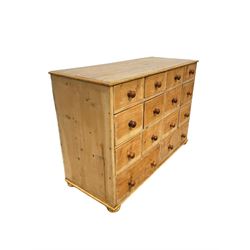 Victorian pine multi drawer chest, with twelve small drawers over two long, raised on bun feet W115cm, H80cm, D46cm