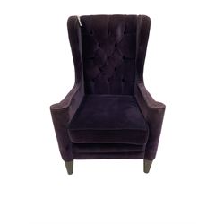 Regency style armchair, upholstered in purple and contrasting grey with black piping and button back, on turned and tapered foot supports 