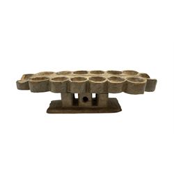 Tribal African 'Mancala' bead game upon pierced pedestal and rectangular stand, W52cm 
