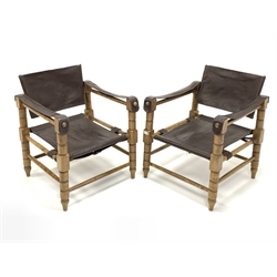 Pair of late 20th century 'safari' type sling chairs, with leather seat, back and arms, raised on a turned beech frame