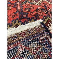Persian Heriz hand knotted carpet, the red and ivory field centred by lozenge medallion 178cm x 300cm 