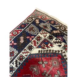 Turkish Dosemealti ivory blue and red ground rug, central elongated lozenge filled with geometric motifs, the guard bands with repeating alternating star motifs an geometric foliate patterns