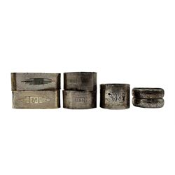 Pair of engine turned silver serviette rings of elongated oval form, engraved with initials Birmingham 1935, pair of octagonal serviette rings and three others 7.3oz (7)