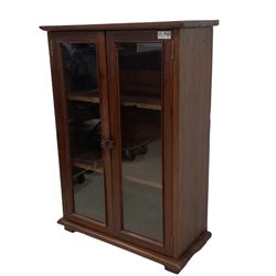 Mid-20th century Burmese teak side cabinet, fitted with two glazed doors with moulded slips enclosing two shelves, bracket feet