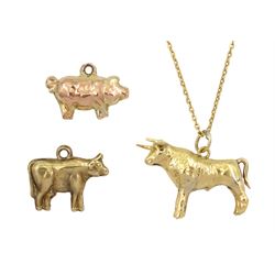 Gold Taurus bull pendant necklace and two cow and pig pendant/charms, all 9ct