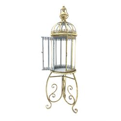 Gilt metal floor lantern with wrought scrolled supports H108cm