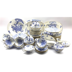 Royal Worcester Blue Dragon pattern dinner service comprising twelve dinner plates, twelve starter plates, twelve dessert plates, two tureens, six teacups & saucers, milk jug, sugar bowl, sauceboat & stand, nine twin-handled soup bowls with eight saucers, large circular shallow bowl, flower shaped dish, pair of oval platters and a larger platter