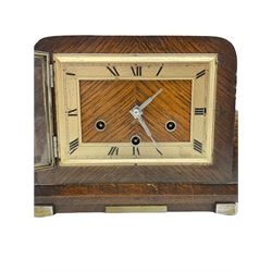 An oak cased German Art Deco 20th century three train Westminster chiming mantle clock striking the hours and chiming the quarters on five gong rods, with a Thomas Haller going barrel eight-day movement, rectangular silver effect chapter with roman numerals and minute track,  chrome baton hands within a flat glass and chrome bezel, strike/silent lever.
With key and pendulum.
