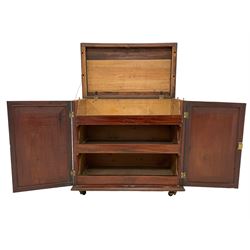Georgian rosewood and mahogany linen press, the moulded rectangular top with lozenge band and crossbanding, two panelled doors with segmented and oval veneers, the interior fitted with three linen slides, lower moulded edge, on brass castors