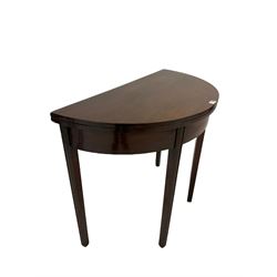 Georgian style demi lune mahogany table, the fold over top raised on square tapered supports 