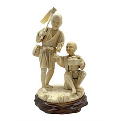 19th century Japanese sectional carved ivory Okimono depicting two shell collectors, one seated with a basket of shells, the other stood with a basket on his back and hoe, signed beneath, on hardwood base H19cm (excluding base)