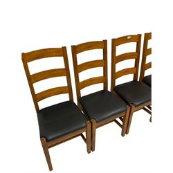 Set four of oak dining chairs with upholstered seat pads, raised on square tapering supports, united by H stretcher