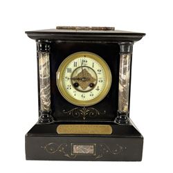 French - late 19th century Belgium slate and marble 8-day mantle clock, with flat top and sloping corners, recessed circular columns to the front in contrasting polished marble and incised gilt decoration, brass presentation plaque dated 1882  enamel two part dial with Arabic numerals,  steel spade hands and applied gilt decoration to the centre, rack striking movement striking on a gong.
With pendulum.