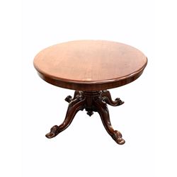 Victorian mahogany loo table, the oval tilt top over baluster turned column and four out played supports carved with scrolls and shields, raised on castors 146cm x 107cm, H75cm